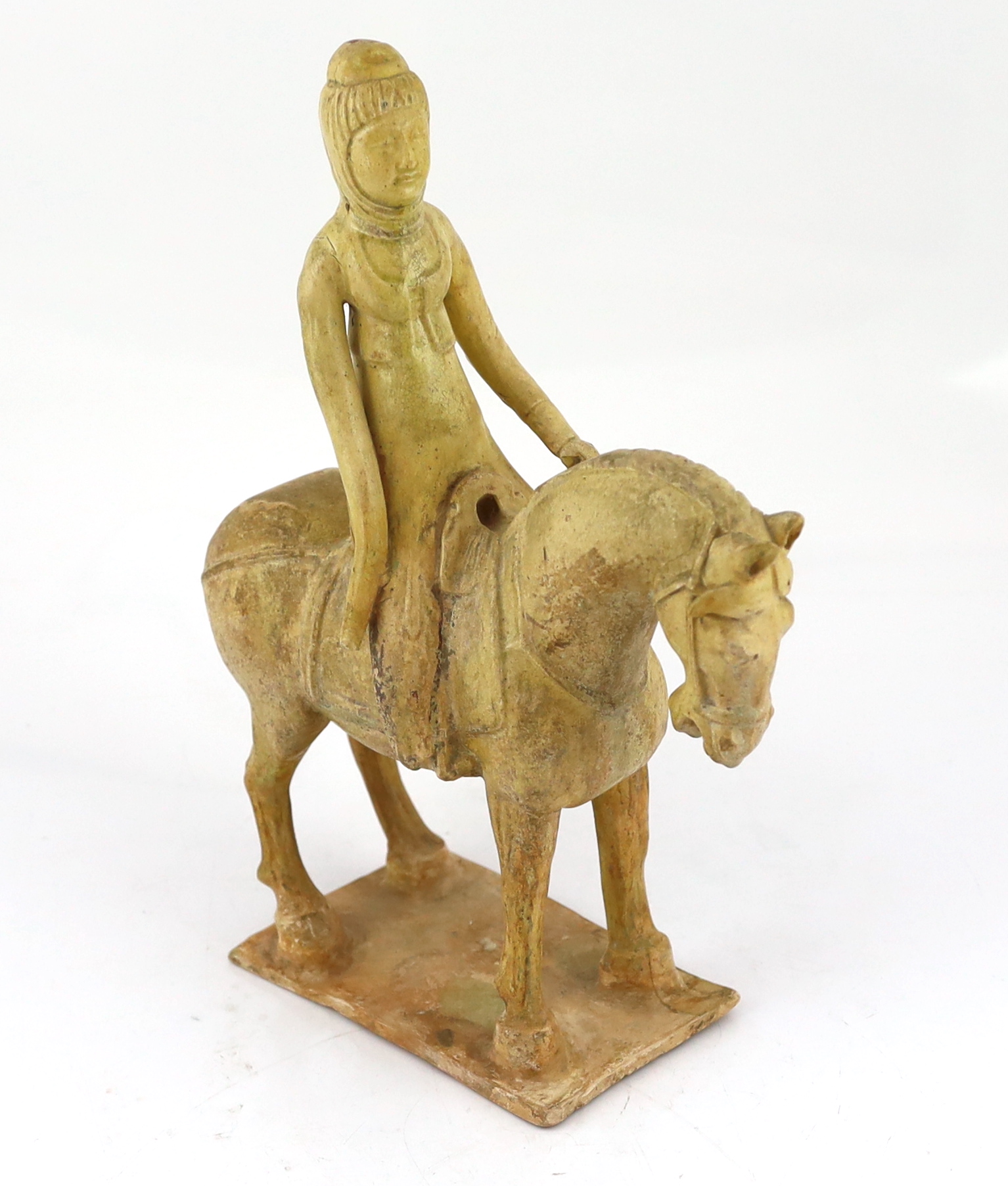 A Chinese straw glazed pottery model of a horse and female rider, Tang dynasty (618-906 AD)